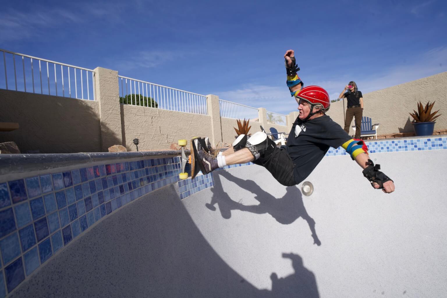 Photo of an Elderly Man Riding a Skateboard